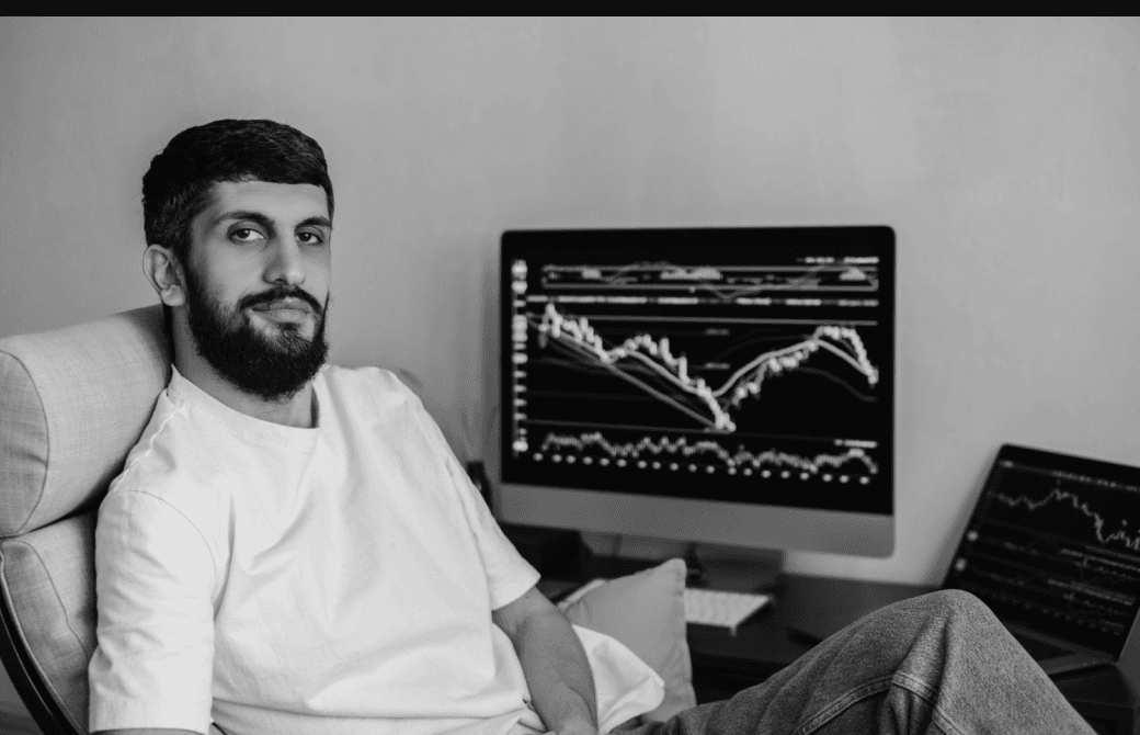 Developer working at a desk with monitoring dashboards